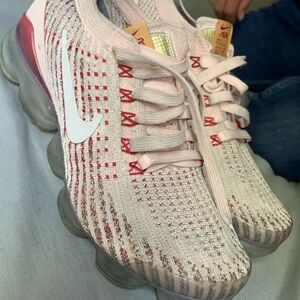 Light pink Nike shoes for active wear slightly dirty